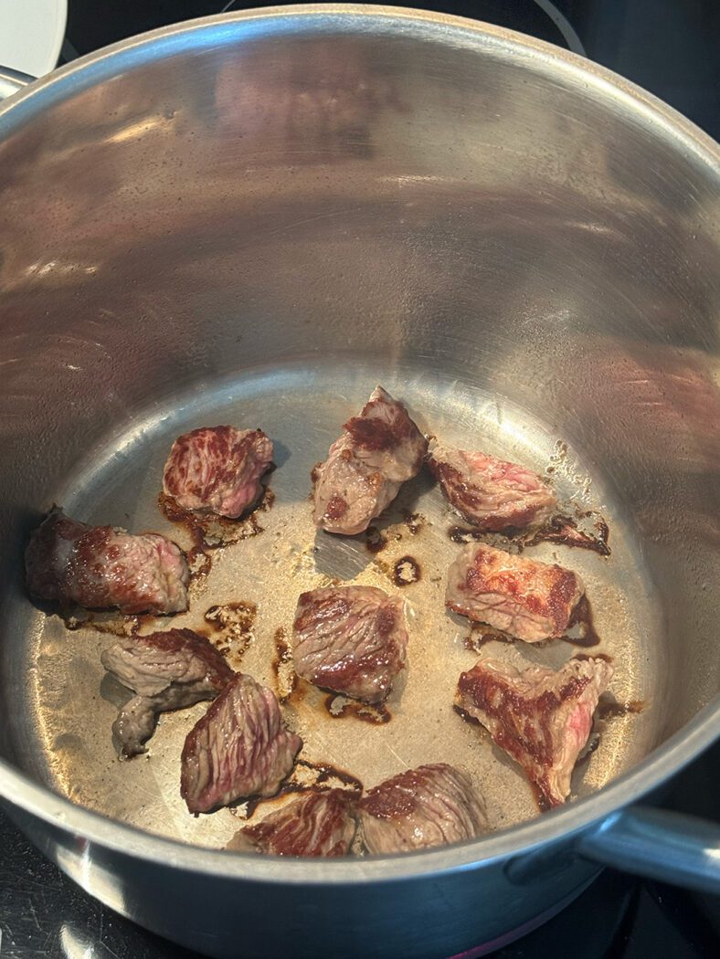 Beef browning in a pot