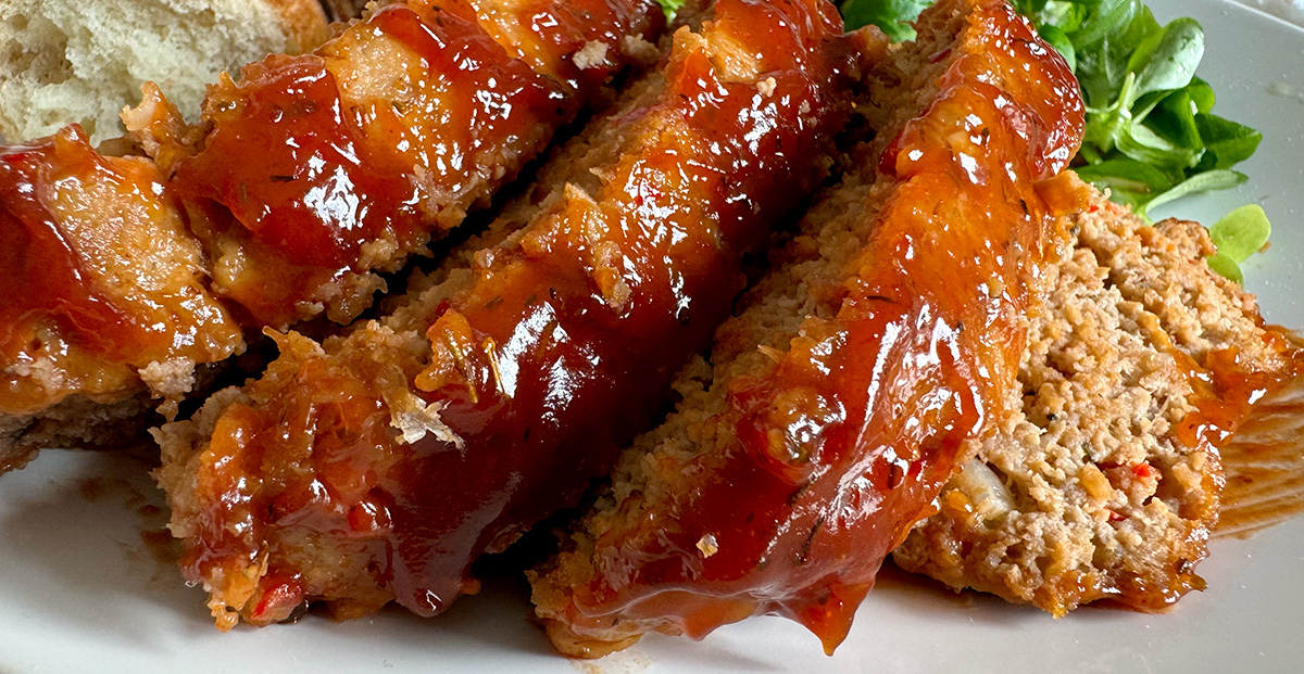 A closeup of homemade meatloaf sliced on a plate