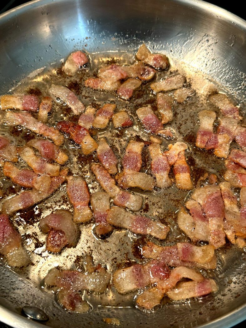 Guanciale frying in a pan