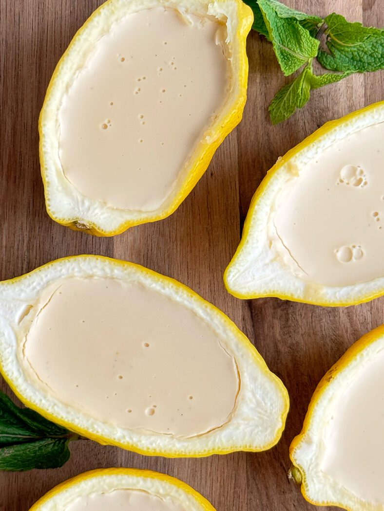 Possets on a cutting board with fresh mint