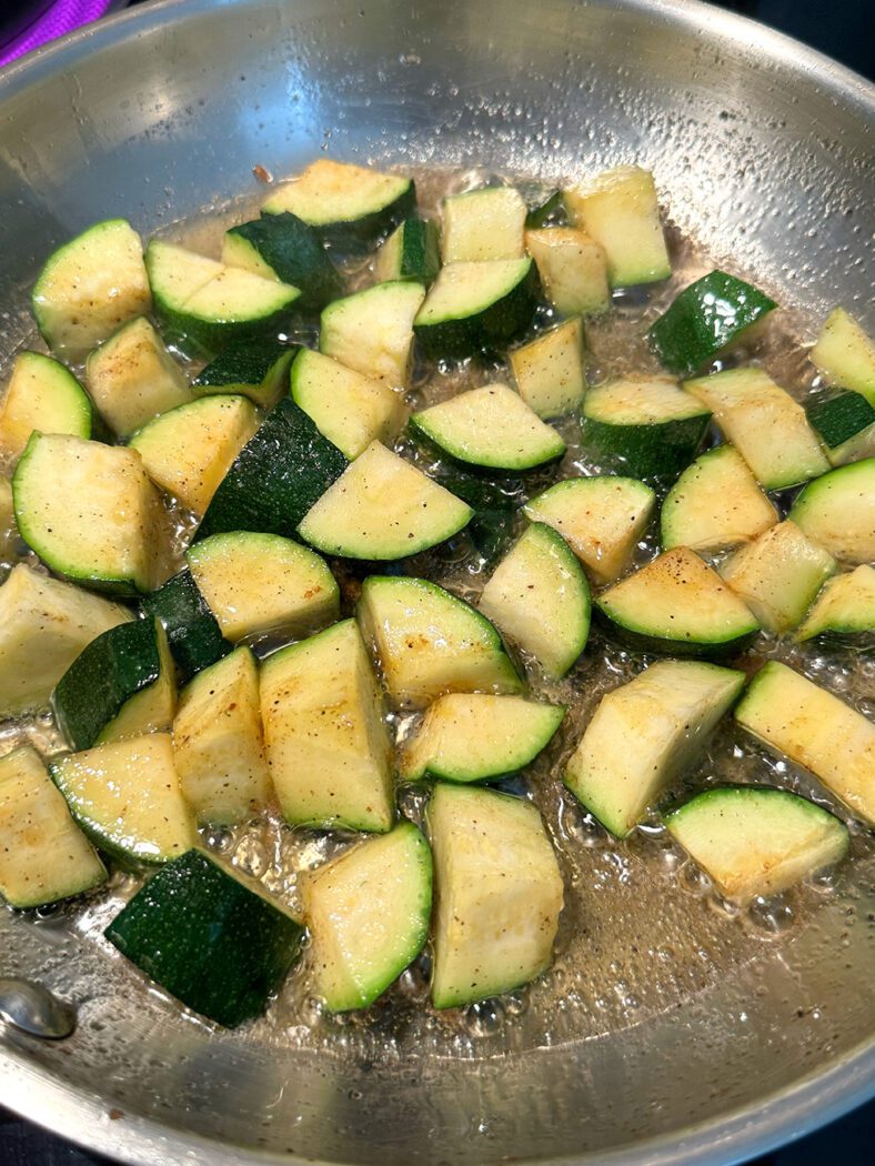 Zucchini frying in a pan